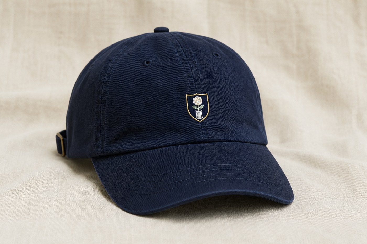 A navy chino dad hat with a small Rosedale Cup seal.